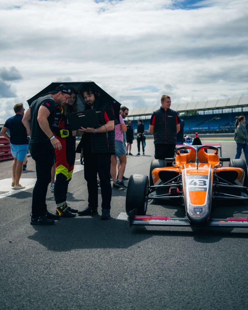data in motorsport and business — racing car with telemetry overlay
